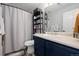 Bathroom featuring a shower with curtain, modern shelving, and clean finishes at 11671 Elkhart, Brighton, CO 80603