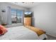 Bedroom featuring a ceiling fan, TV on dresser, and a large window providing ample natural light at 11671 Elkhart, Brighton, CO 80603