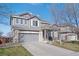 Two-story home features a two-car garage, landscaped yard, and well-maintained exterior at 11671 Elkhart, Brighton, CO 80603