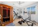 Home gym featuring a sauna, an inversion table, a weight bench, guitars, and plenty of natural light from three windows at 11671 Elkhart, Brighton, CO 80603