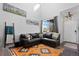 Bright living room showcases a sectional sofa, large windows, and stylish decor at 11671 Elkhart, Brighton, CO 80603