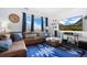 Bright living area with a comfortable couch, fireplace, built-in shelving, and stylish decor throughout at 11671 Elkhart, Brighton, CO 80603