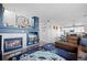 Cozy living space featuring a fireplace, built-in shelving, and comfortable seating area at 11671 Elkhart, Brighton, CO 80603