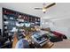 Open office with built-in shelving, a ceiling fan, and comfortable seating area for relaxing or casual conversation at 11671 Elkhart, Brighton, CO 80603