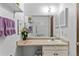 Bathroom with white vanity, toilet and a mirrored medicine cabinet at 8710 Carr Loop, Arvada, CO 80005