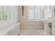 Cozy bathroom featuring a sink, radiator, and window with white shutters at 2222 E 7Th Avenue Pkwy, Denver, CO 80206