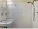 Shower room with a bright white tile surround, updated shower head, and sink at 2222 E 7Th Avenue Pkwy, Denver, CO 80206