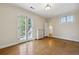 Empty bedroom with hardwood floors, French doors, and a radiator at 2222 E 7Th Avenue Pkwy, Denver, CO 80206