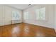 Empty bedroom with hardwood floors, windows, and white trim at 2222 E 7Th Avenue Pkwy, Denver, CO 80206