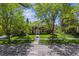 Charming brick home with lush lawn and mature trees; welcoming curb appeal at 2222 E 7Th Avenue Pkwy, Denver, CO 80206