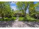 Charming brick home with lush lawn and mature trees; welcoming curb appeal at 2222 E 7Th Avenue Pkwy, Denver, CO 80206