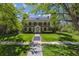 Beautiful two-story home featuring brick facade, shutters, and manicured front lawn at 2222 E 7Th Avenue Pkwy, Denver, CO 80206