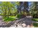 Elegant home exterior featuring mature trees, landscaped front yard, and a private driveway entrance at 2222 E 7Th Avenue Pkwy, Denver, CO 80206