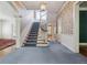 Spacious foyer with staircase, carpeted floor, and stylish decorative wallpaper at 2222 E 7Th Avenue Pkwy, Denver, CO 80206