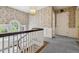 Upstairs hallway with a carpeted floor, decorative wallpaper, hanging chandelier, and view of the stairwell at 2222 E 7Th Avenue Pkwy, Denver, CO 80206