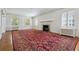 Spacious living room featuring a fireplace, hardwood floors, and large windows with bright natural light at 2222 E 7Th Avenue Pkwy, Denver, CO 80206