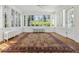 Bright sunroom with hardwood floors, multiple windows, and classic radiator at 2222 E 7Th Avenue Pkwy, Denver, CO 80206