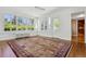 Sun-filled room featuring hardwood floors, large windows, and classic architectural details at 2222 E 7Th Avenue Pkwy, Denver, CO 80206