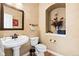 Charming powder room features a pedestal sink, decorative mirror, and stylish wall accents at 8389 Owl Roost Ct, Parker, CO 80134
