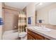 Bright bathroom featuring a tub and shower combo with a colorful shower curtain and a vanity with a mirror at 8389 Owl Roost Ct, Parker, CO 80134