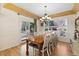 Bright dining room with a wooden table set and lots of natural light from windows and a door to the outside at 8389 Owl Roost Ct, Parker, CO 80134