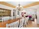 Dining room with long table, chandelier, and view into a recreation area with a billiard table at 8389 Owl Roost Ct, Parker, CO 80134