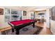 Game room with a pool table and large windows, situated near the dining area at 8389 Owl Roost Ct, Parker, CO 80134
