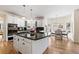 Modern kitchen featuring an island with cooktop and breakfast nook with natural light at 8389 Owl Roost Ct, Parker, CO 80134