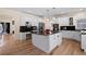 Spacious kitchen with white cabinets, black granite countertops, and stainless steel appliances at 8389 Owl Roost Ct, Parker, CO 80134