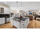 Open-concept kitchen with an island cooktop and views into the adjacent living room at 8389 Owl Roost Ct, Parker, CO 80134