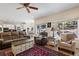 Open living area with large windows, hardwood flooring and seamless access to the kitchen at 8389 Owl Roost Ct, Parker, CO 80134