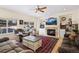 Inviting living room with a fireplace, built-in shelves, comfortable seating, and large windows at 8389 Owl Roost Ct, Parker, CO 80134