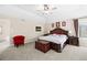 Relaxing main bedroom with a decorative bed frame, tray ceilings, and natural light at 8389 Owl Roost Ct, Parker, CO 80134