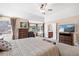 Serene main bedroom with an ensuite bathroom entrance, bay windows, and ceiling fan at 8389 Owl Roost Ct, Parker, CO 80134