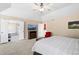 Bright main bedroom with ceiling fan, access to bathroom, walk-in closet and mountain artwork at 8389 Owl Roost Ct, Parker, CO 80134