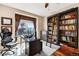 Well-lit home office with built-in bookcase and ladder, perfect for a productive workspace at 8389 Owl Roost Ct, Parker, CO 80134