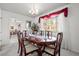 Bright dining room with a large table, seating for six, and window with soft curtains, creating a perfect gathering space at 2165 S Nucla Way, Aurora, CO 80013