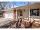 Inviting front porch with brick accents, leading to a well-lit entryway. A welcoming floral wreath adorns the front door at 2165 S Nucla Way, Aurora, CO 80013