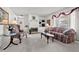 Bright and airy living room featuring a cozy fireplace, plush seating, and a large window with natural light at 2165 S Nucla Way, Aurora, CO 80013