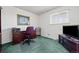 Functional office features ample desk space, bright window, and carpeted floors at 2165 S Nucla Way, Aurora, CO 80013