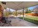 A covered patio offers shade and seating, overlooking a well-maintained yard with mature landscaping at 2165 S Nucla Way, Aurora, CO 80013