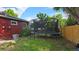Home backyard featuring a trampoline with netting, a privacy fence, and lush lawn at 4543 Cathay St, Denver, CO 80249