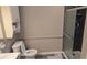 Cozy bathroom features gray tile shower and gray walls at 4543 Cathay St, Denver, CO 80249