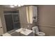 Bathroom featuring gray tiled shower with sliding door, and gray vanity at 4543 Cathay St, Denver, CO 80249