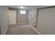 Clean bedroom features neutral carpet, a bright window, and closet at 4543 Cathay St, Denver, CO 80249
