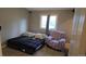 Comfortable bedroom featuring a queen-sized bed, chair, and a bright window at 4543 Cathay St, Denver, CO 80249