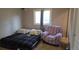 Carpeted bedroom with window and chair at 4543 Cathay St, Denver, CO 80249