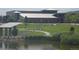 Scenic view of community center with a pond, manicured lawn, walkways, and landscaping at 4543 Cathay St, Denver, CO 80249