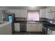 A well-appointed kitchen with white cabinets, stainless steel appliances, and modern finishes at 4543 Cathay St, Denver, CO 80249