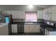 An open kitchen with white cabinetry, stainless steel appliances, and a window over the sink at 4543 Cathay St, Denver, CO 80249